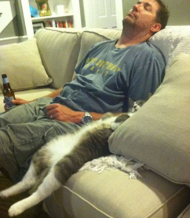 Man and cat are sleeping on the couch
