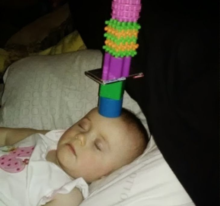 Pyramid of toys on the forehead of a child